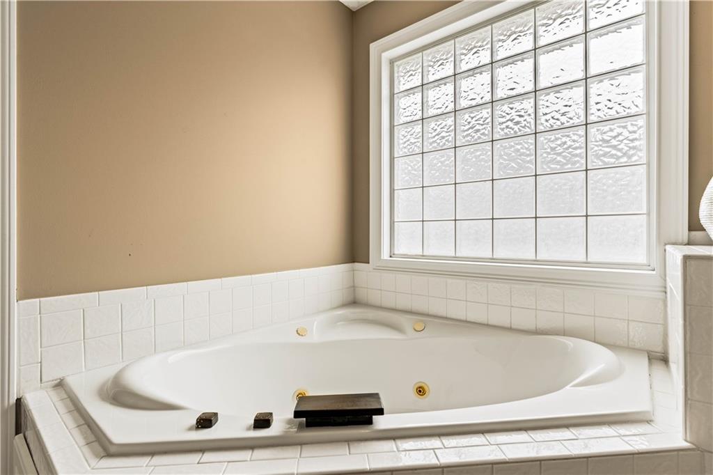 638 Glen Valley Way Dacula, GA 30019 - Photo 35 of 61 a bath tub sitting in a bathroom next to a window