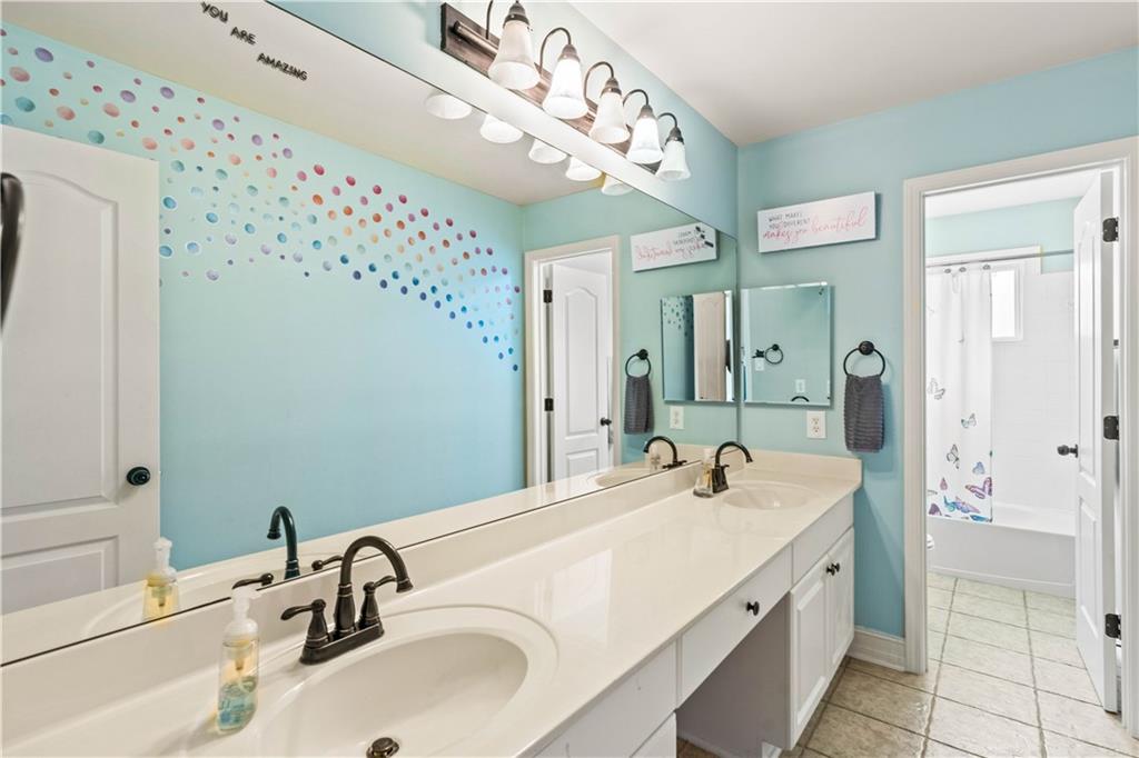 638 Glen Valley Way Dacula, GA 30019 - Photo 39 of 61 a bathroom with a sink and a mirror