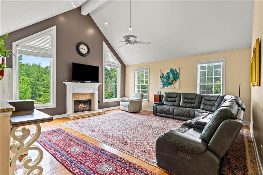 638 Glen Valley Way Dacula, GA 30019 - Photo 4 of 61 a living room with furniture a flat screen tv and a fireplace