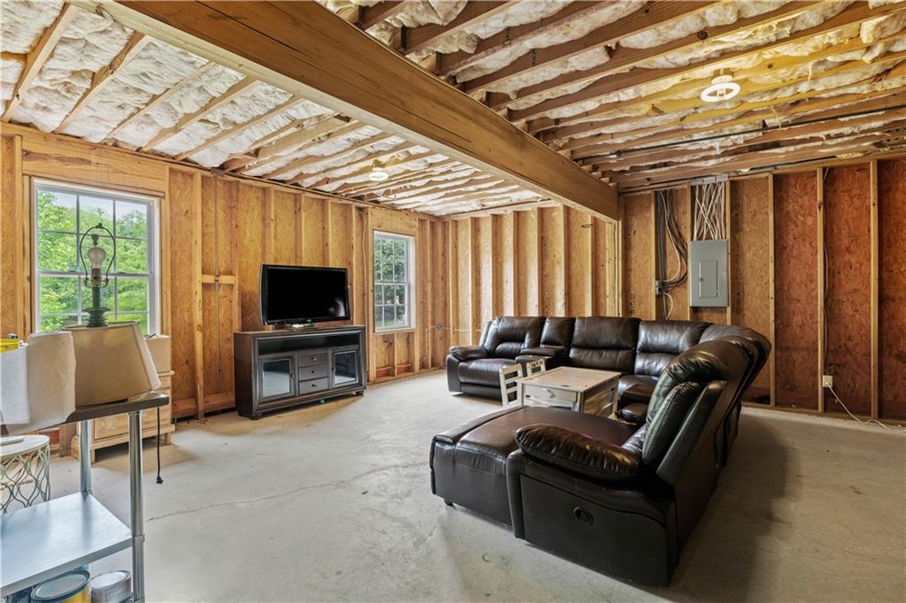 638 Glen Valley Way Dacula, GA 30019 - Photo 48 of 61 a living room with furniture a flat screen tv and a large window