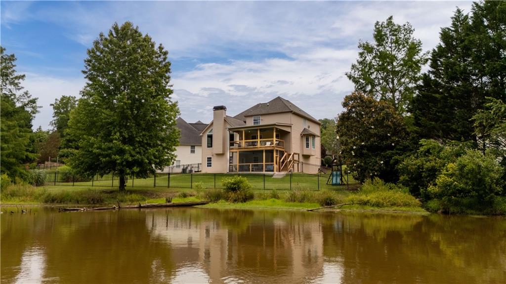 638 Glen Valley Way Dacula, GA 30019 - Photo 6 of 61 a view of a lake with a house in the background