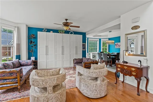 a living room with furniture and a wooden floor