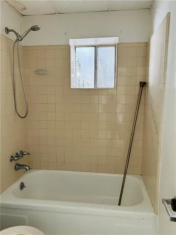 a bathroom with a toilet a sink and shower