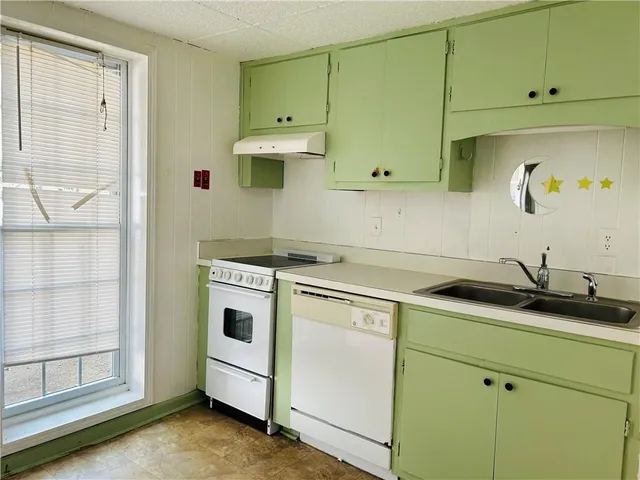 a kitchen with a sink and cabinets
