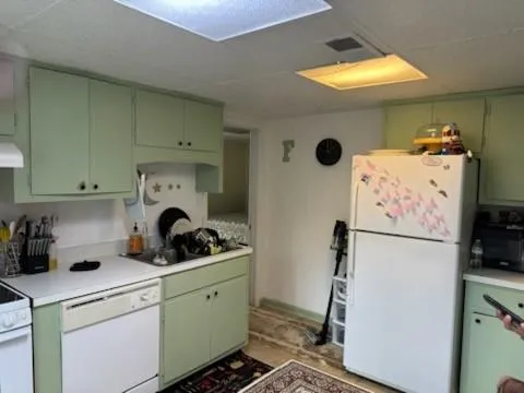 a kitchen with cabinets a washer and dryer