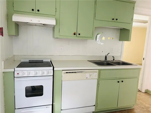 a kitchen with cabinets and white stainless steel appliances