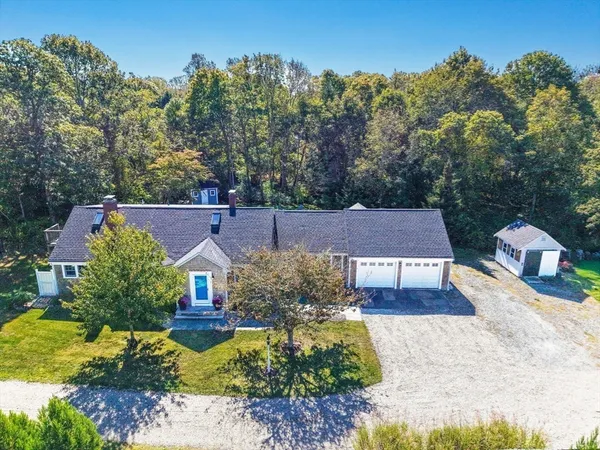 a aerial view of a house with a yard basket ball court and outdoor seating