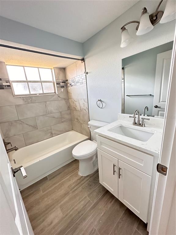 4407 Summersun Drive New Port Richey, FL 34652 - Photo 14 of 34 a bathroom with a sink a toilet and a bathtub