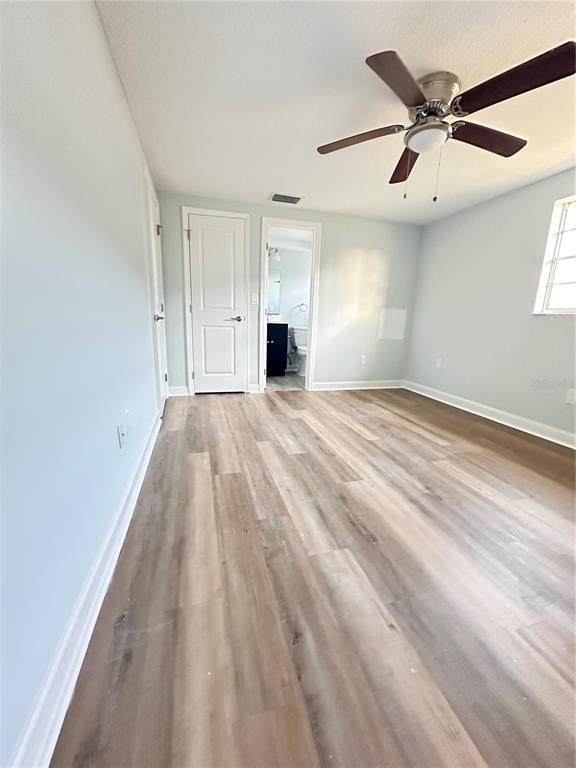 4407 Summersun Drive New Port Richey, FL 34652 - Photo 17 of 34 an empty room with chandelier fan and windows