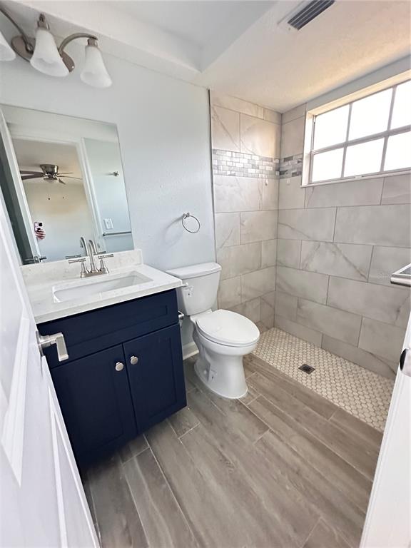 4407 Summersun Drive New Port Richey, FL 34652 - Photo 21 of 34 a bathroom with a sink toilet a mirror and shower