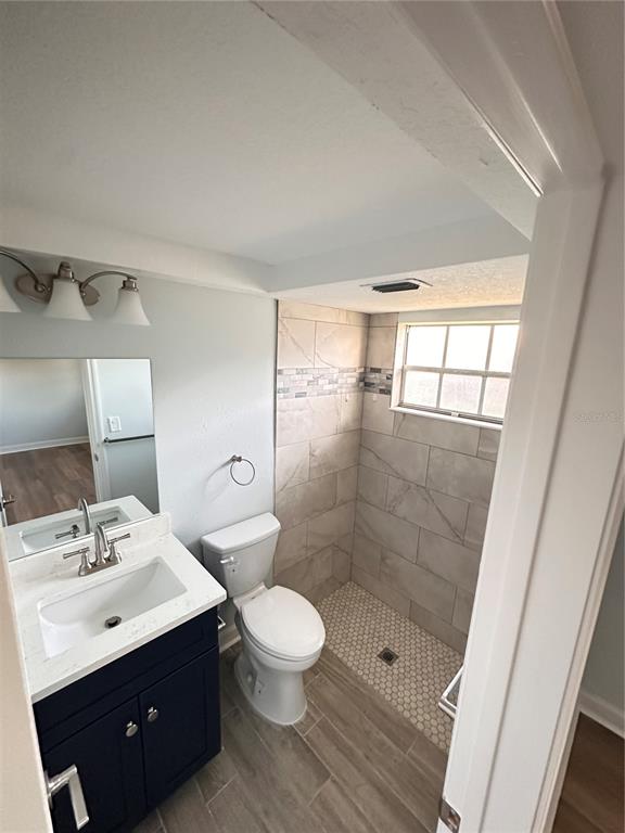 4407 Summersun Drive New Port Richey, FL 34652 - Photo 22 of 34 a bathroom with a double vanity sink toilet and shower