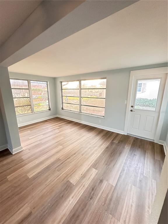 4407 Summersun Drive New Port Richey, FL 34652 - Photo 24 of 34 an empty room with wooden floor and windows