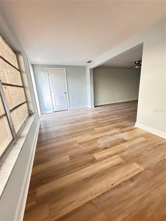 4407 Summersun Drive New Port Richey, FL 34652 - Photo 25 of 34 a view of an empty room with wooden floor and a window