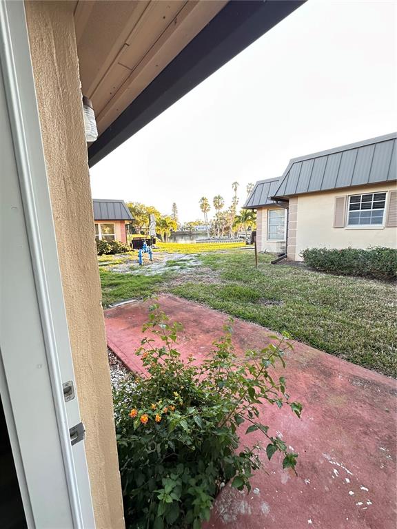 4407 Summersun Drive New Port Richey, FL 34652 - Photo 29 of 34 a view of a backyard with table and chairs and wooden fence