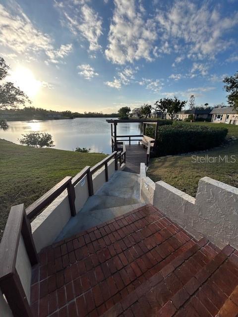 4407 Summersun Drive New Port Richey, FL 34652 - Photo 34 of 34 a view of a lake with outdoor seating