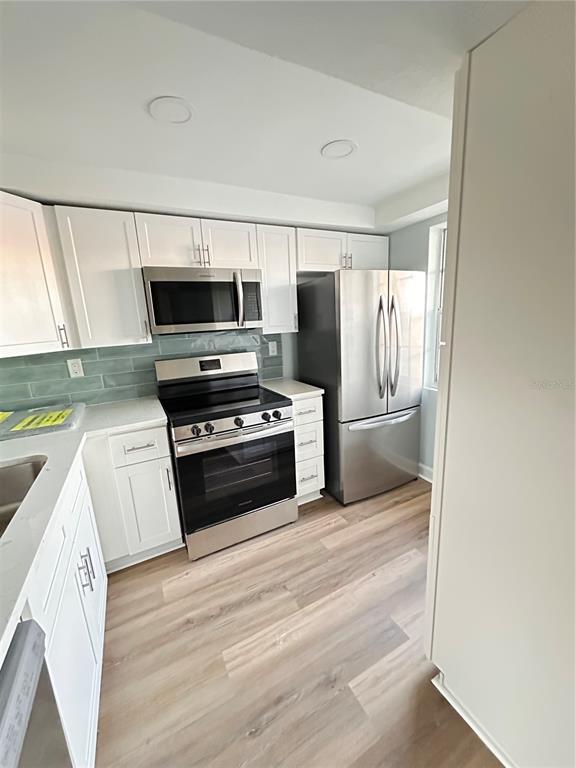 4407 Summersun Drive New Port Richey, FL 34652 - Photo 5 of 34 a kitchen with a refrigerator stove and microwave