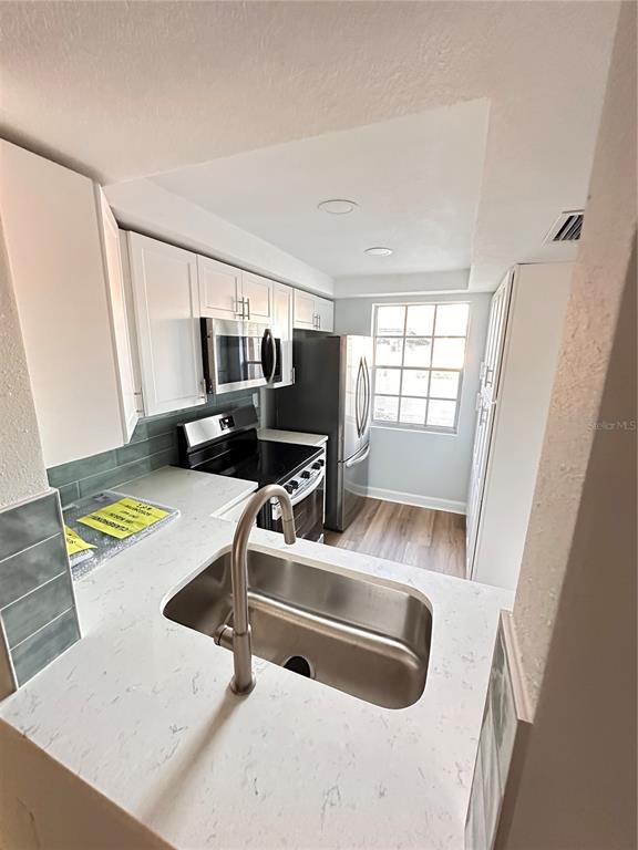 4407 Summersun Drive New Port Richey, FL 34652 - Photo 8 of 34 a view of kitchen with a sink and a refrigerator