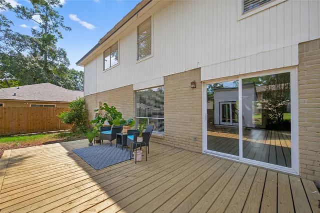 a view of a deck with table and chairs and wooden floor
