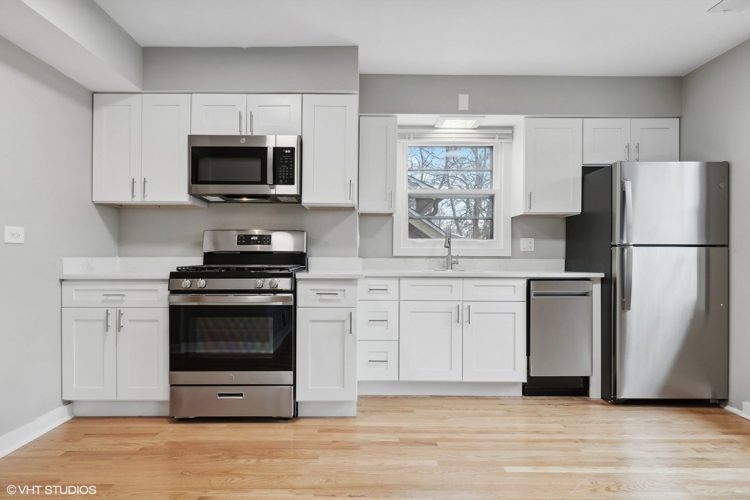 2490 Green Bay Road Highland Park, IL 60035 - Photo 18 of 29 a kitchen with white cabinets stainless steel appliances and a window