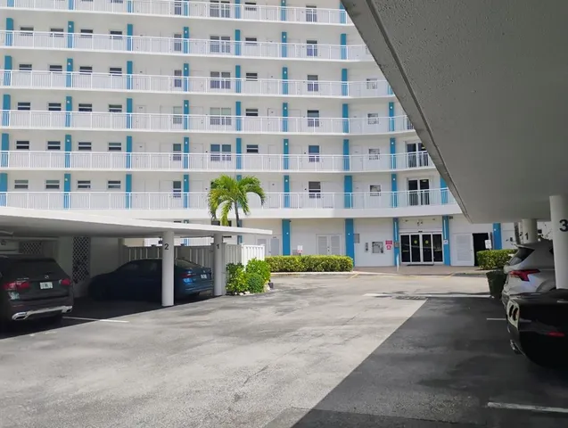 a front view of a building with a garden