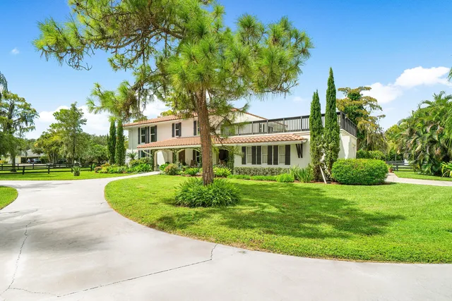 a view of an entryway with wooden floor and a livingroom