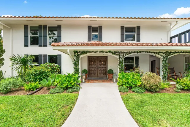 a living room with fireplace furniture and a large window