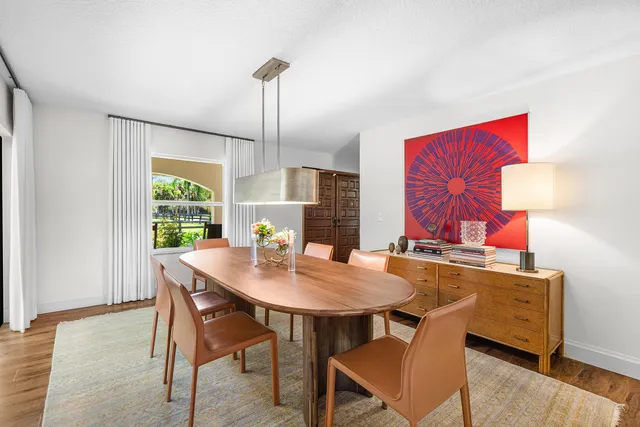 a kitchen with white cabinets and chandelier