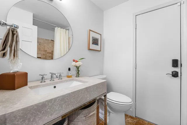 a bathroom with a sink vanity and mirror