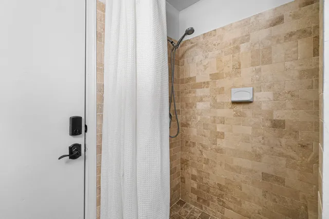a bathroom with a toilet and a shower