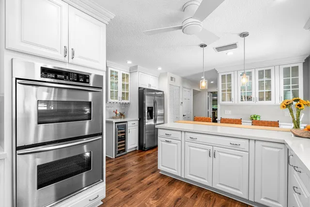 a bedroom with a large bed and a tv on dresser