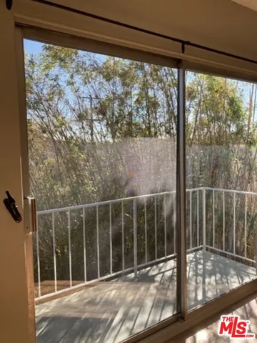 a view of a glass door with a big yard