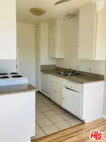 a kitchen with granite countertop cabinets and sink