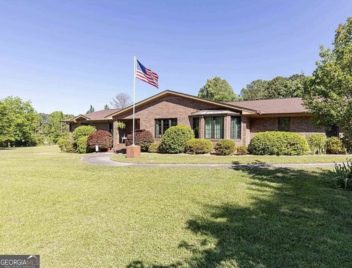 a front view of a house with swimming pool having outdoor seating