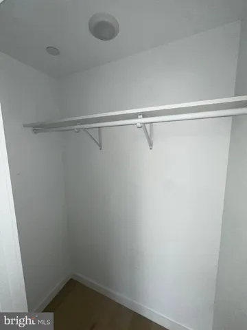 a view of hallway with a large window and wooden floor