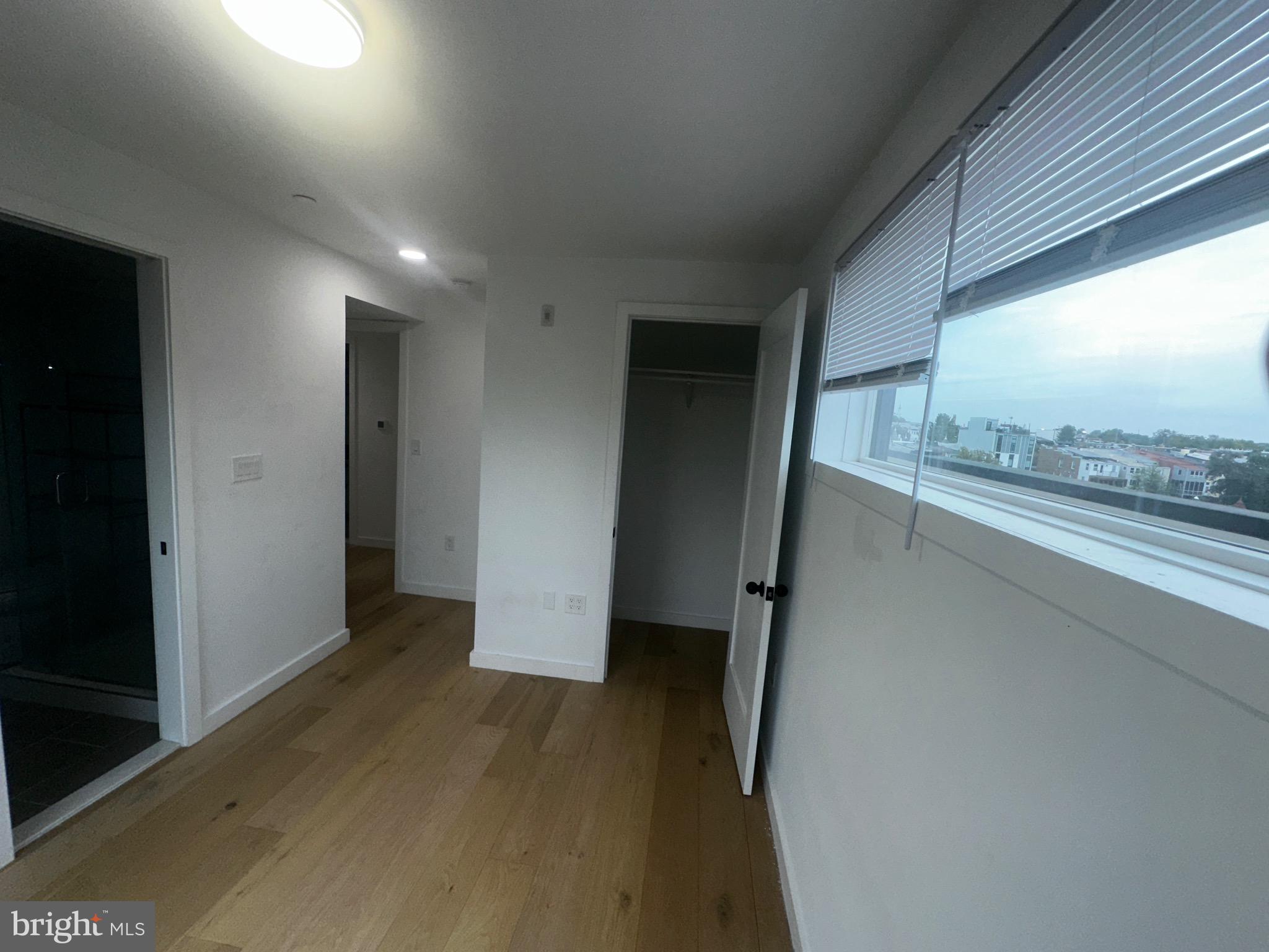 3601 14th Street Northwest Washington, DC 20010 - Photo 20 of 31 a view of hallway with a large window and wooden floor
