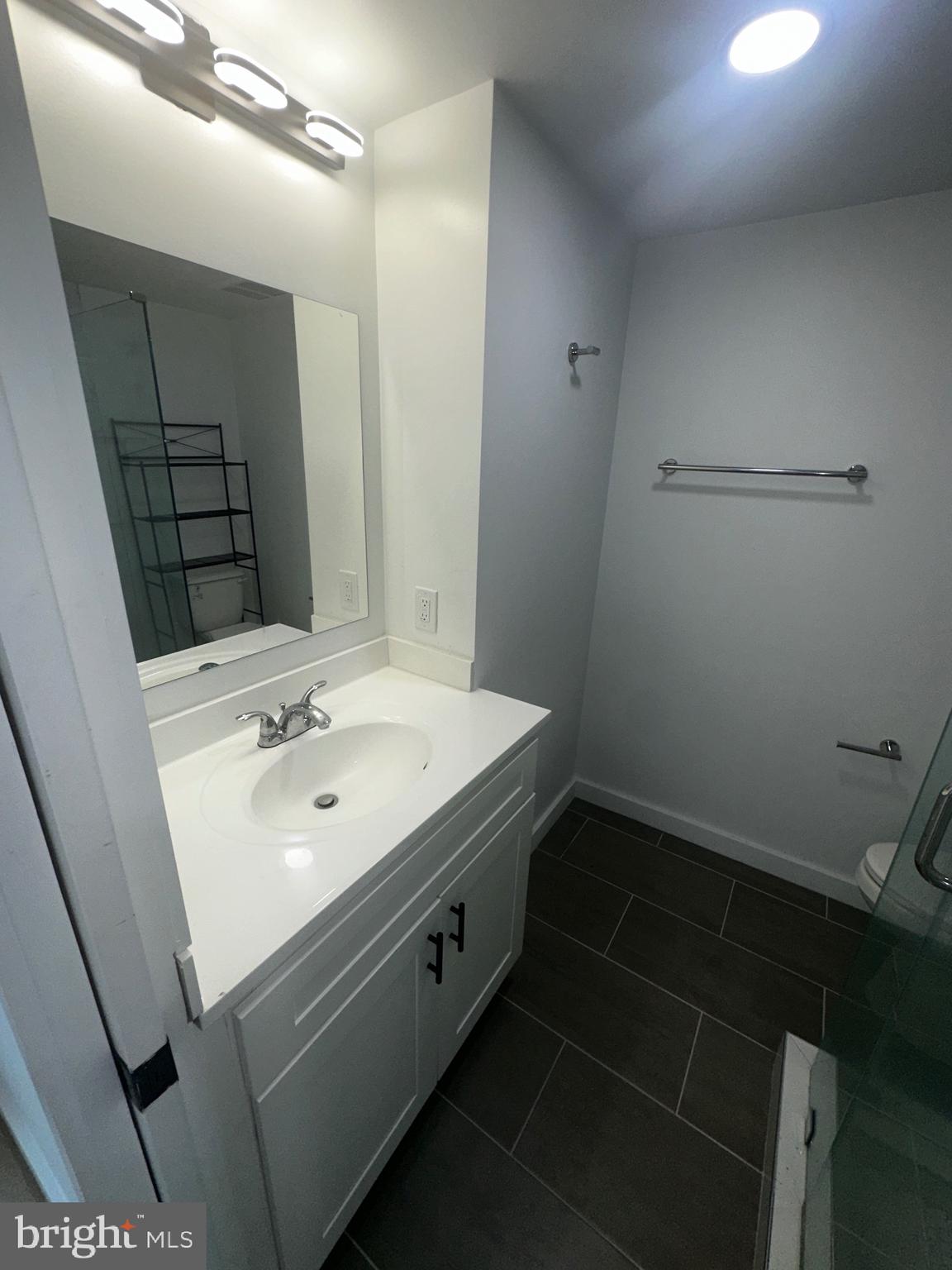 3601 14th Street Northwest Washington, DC 20010 - Photo 29 of 31 a bathroom with a sink a toilet and a mirror