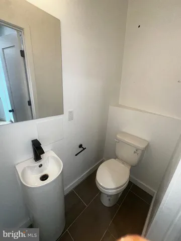 a white toilet sitting next to a bathroom sink