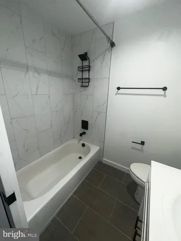 a bathroom with a bathtub and a toilet