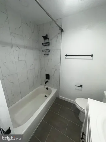 a bathroom with a bathtub and toilet