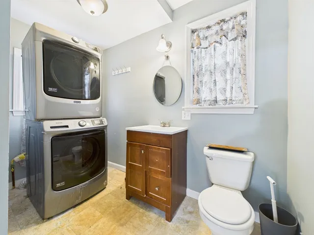 a bathroom with a toilet a sink and mirror