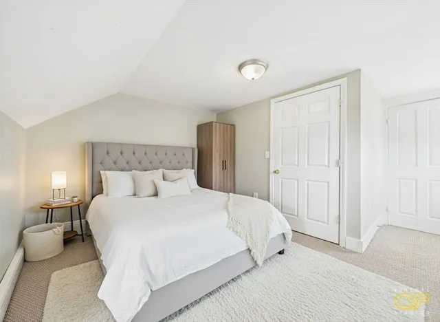 a bedroom with a bed and a night lamp