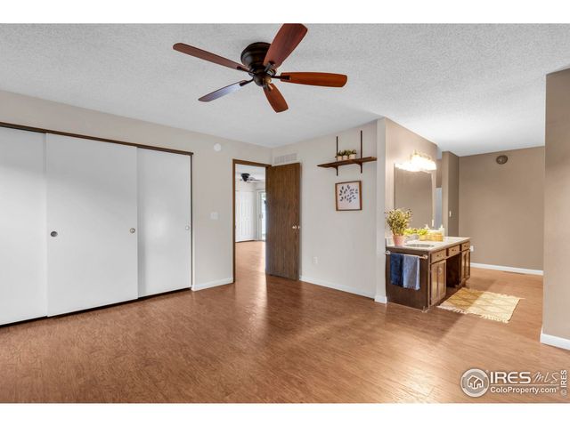 a view of an empty room and kitchen view