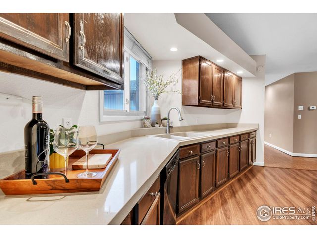 a kitchen with a sink cabinets and a wooden floor