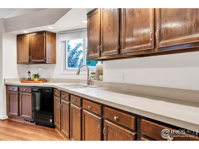 a kitchen with a sink cabinets and stainless steel appliances