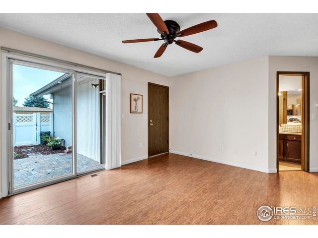 a view of a livingroom with a ceiling fan and wooden floor