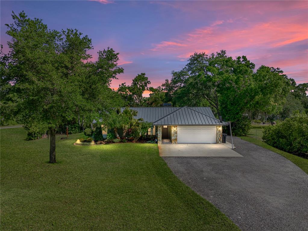 a front view of a house with a garden