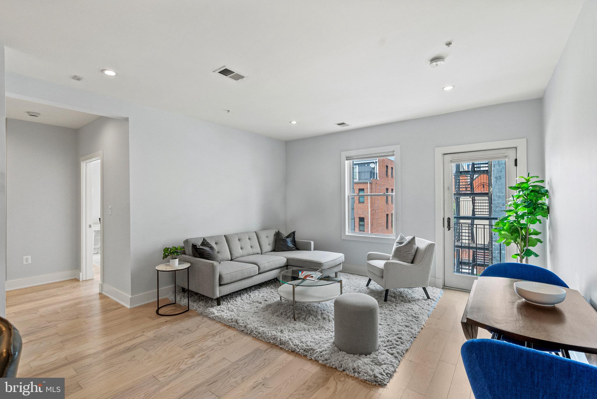 a living room with furniture and a wooden floor