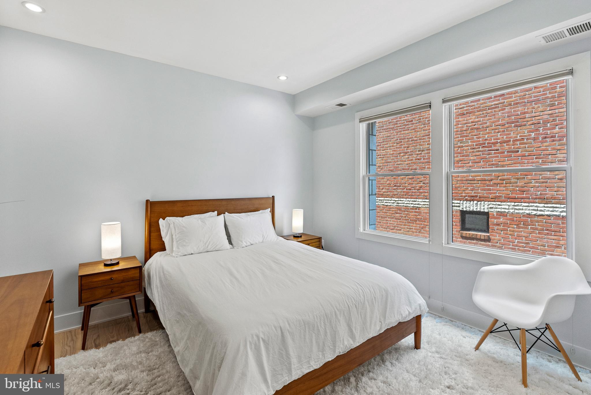 2101 11th Street Northwest, Unit 302 Washington, DC 20001 - Photo 11 of 26 a bedroom with a bed a chair and next to a window