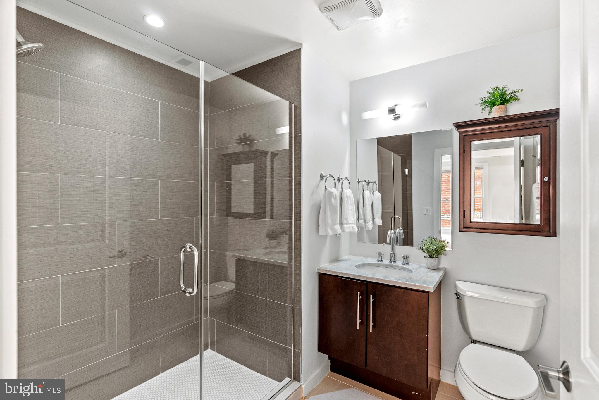 2101 11th Street Northwest, Unit 302 Washington, DC 20001 - Photo 13 of 26 a bathroom with a sink a toilet and shower
