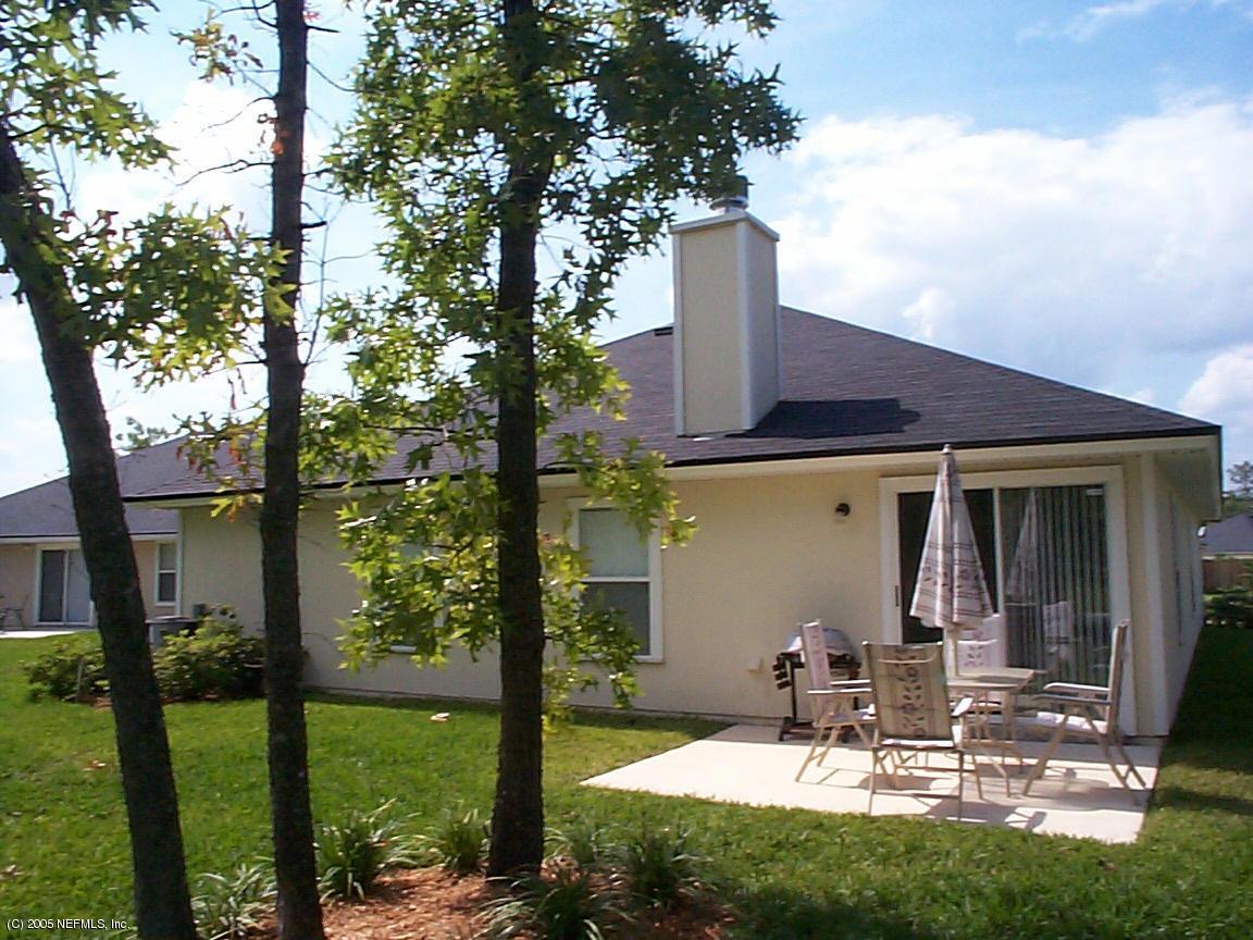 4316 Rye Jacksonville, FL 32259 - Photo 2 of 3 a view of a patio with table and chairs potted plants and a large tree